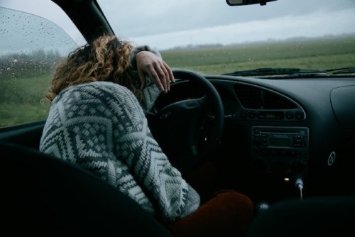 woman asleep behind the wheel