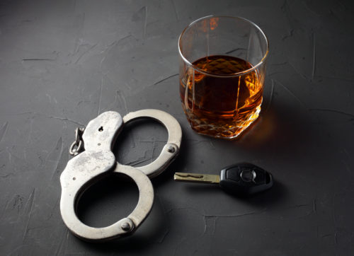 DWI suspended license handcuffs keys alcohol drink